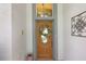 Elegant front door with a wreath and sidelights at 5533 Grove Mnr, Lady Lake, FL 32159