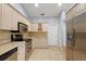 Bright kitchen with stainless steel appliances and light wood cabinets at 5533 Grove Mnr, Lady Lake, FL 32159