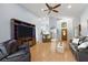 Living room with hardwood floors, leather sofas, and a large TV at 5533 Grove Mnr, Lady Lake, FL 32159