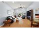 Spacious living room with hardwood floors, a fireplace, and lots of natural light at 5533 Grove Mnr, Lady Lake, FL 32159