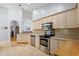 Kitchen with stainless steel appliances and light wood cabinets at 5533 Grove Mnr, Lady Lake, FL 32159