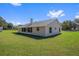 House back view, showcasing screened porch and yard at 7921 Jacksons River Rd, Leesburg, FL 34788