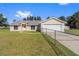 Single-story home with attached garage and fenced yard at 7921 Jacksons River Rd, Leesburg, FL 34788