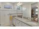 Spa-like bathroom featuring double sinks and a walk-in shower at 8099 Bridgeport Bay Cir, Mount Dora, FL 32757