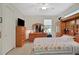 Bright bedroom with a comfortable bed and ample closet space at 8099 Bridgeport Bay Cir, Mount Dora, FL 32757