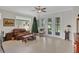 Living room with leather couch, wood coffee table, and view of backyard at 8099 Bridgeport Bay Cir, Mount Dora, FL 32757