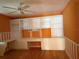 Bright home office features built-in white cabinets and wood flooring at 113 Costa Mesa Dr, The Villages, FL 32159