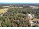 Aerial view showing home nestled in a wooded area with nearby amenities at 1415 E 9Th Ave, Mount Dora, FL 32757