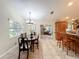 Dining room with hardwood floors, chandelier and view of kitchen and living room at 1415 E 9Th Ave, Mount Dora, FL 32757