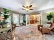 Bright sunroom with wicker chairs, area rug, and view of kitchen at 1415 E 9Th Ave, Mount Dora, FL 32757