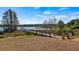 Scenic lakefront view with wooden pier and walkway at 15414 Groose Point Ln, Clermont, FL 34714