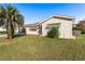 Front view of the house with palm tree and lawn at 17787 Se 97Th Ave, Summerfield, FL 34491