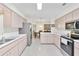 Open concept kitchen with stainless steel appliances and a view to dining area at 17787 Se 97Th Ave, Summerfield, FL 34491