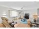 Living room features light colored sofas and a large flat screen tv at 17787 Se 97Th Ave, Summerfield, FL 34491