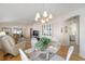 Bright dining room with hardwood floors and a view into the living room at 1859 Mount Pleasant Ter, The Villages, FL 32162