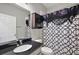Small bathroom with dark countertop and geometric shower curtain at 29549 Caspian St, Leesburg, FL 34748