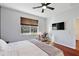 Bright bedroom featuring wood floors and a view of the backyard at 29549 Caspian St, Leesburg, FL 34748