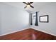 Simple bedroom with wood floors and large window with curtains at 29549 Caspian St, Leesburg, FL 34748