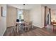 Elegant dining room with a glass-top table and hardwood floors at 29549 Caspian St, Leesburg, FL 34748