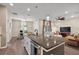 Open kitchen with large island, stainless steel appliances, and breakfast bar at 29549 Caspian St, Leesburg, FL 34748