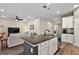 Open kitchen features an island and breakfast bar, flows into living room at 29549 Caspian St, Leesburg, FL 34748