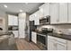 Modern kitchen with stainless steel appliances and an island at 29549 Caspian St, Leesburg, FL 34748