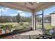 Screened porch with patio furniture and view of backyard at 29549 Caspian St, Leesburg, FL 34748