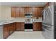 Modern kitchen with stainless steel appliances and wood cabinets at 30628 Lipizzan Ter, Mount Dora, FL 32757