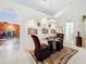 Open dining room with a glass-top table and four chairs at 31748 Parkdale Dr, Leesburg, FL 34748