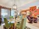 Dining area with glass-top table and chairs, open to living room and kitchen at 31748 Parkdale Dr, Leesburg, FL 34748