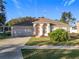 One-story house with attached garage, manicured lawn, and a walkway at 31748 Parkdale Dr, Leesburg, FL 34748