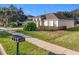 House exterior with landscaped lawn at 31748 Parkdale Dr, Leesburg, FL 34748