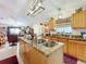 Open concept kitchen with island and views into the living room at 31748 Parkdale Dr, Leesburg, FL 34748