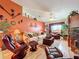 Spacious living room featuring orange accent wall and comfortable furnishings at 31748 Parkdale Dr, Leesburg, FL 34748