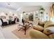 Living room with beige sofa, glass coffee table, and decorative accents at 31748 Parkdale Dr, Leesburg, FL 34748