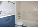 Updated bathroom features a vanity with blue cabinets and a bathtub at 3211 Lupine Way, Lake Wales, FL 33898