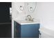 Stylish bathroom with blue vanity and white countertop at 3211 Lupine Way, Lake Wales, FL 33898