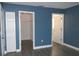 Bedroom with blue walls, hardwood floors, and ample closet space at 3211 Lupine Way, Lake Wales, FL 33898