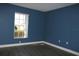 Blue bedroom with window and hardwood floors at 3211 Lupine Way, Lake Wales, FL 33898