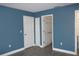 Spacious bedroom with two closets and blue walls at 3211 Lupine Way, Lake Wales, FL 33898