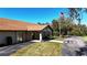 Community clubhouse with stone facade and flag at 3211 Lupine Way, Lake Wales, FL 33898