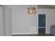 Bright dining room with modern light fixture and view to living room at 3211 Lupine Way, Lake Wales, FL 33898