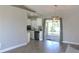 Open concept dining area with wood floors and kitchen view at 3211 Lupine Way, Lake Wales, FL 33898