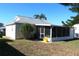 Home's back exterior with screened porch and yard at 3211 Lupine Way, Lake Wales, FL 33898