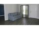 Living room featuring a gray couch and large window with natural light at 3211 Lupine Way, Lake Wales, FL 33898