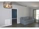 Spacious living room with hardwood floors and stylish light fixture at 3211 Lupine Way, Lake Wales, FL 33898