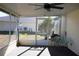 Screened porch with ceiling fan and backyard view at 3211 Lupine Way, Lake Wales, FL 33898