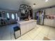 Kitchen with island, pot rack, and stainless steel appliances at 32628 Gere Ln, Sorrento, FL 32776