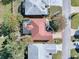 Aerial view of single-story home with red tile roof and screened patio at 33236 Grand Cypress Way, Leesburg, FL 34748