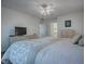 King-size bed in bright bedroom with ensuite bathroom access at 33236 Grand Cypress Way, Leesburg, FL 34748